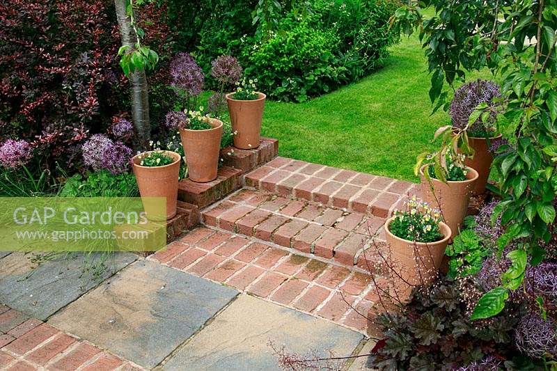 Pots of pansies beside brick steps