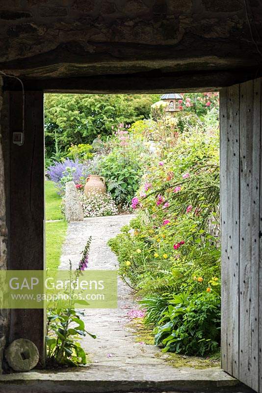 View through barn door into the cottage garden in June