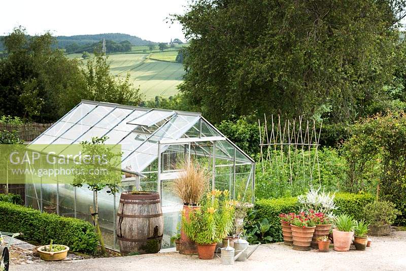 Greenhouse surrounded by pots and containers 