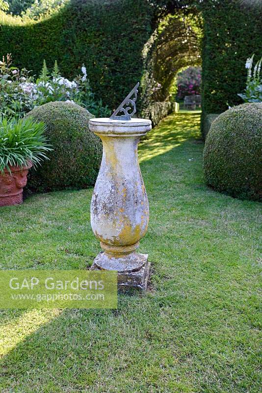 Traditional sundial in English country garden. 