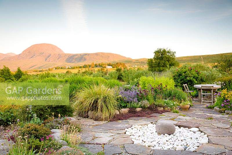 View of modern garden in Scotland, with mountains in the background. 