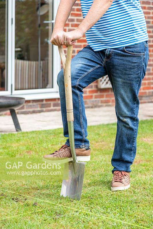 Man using spade to remove turf