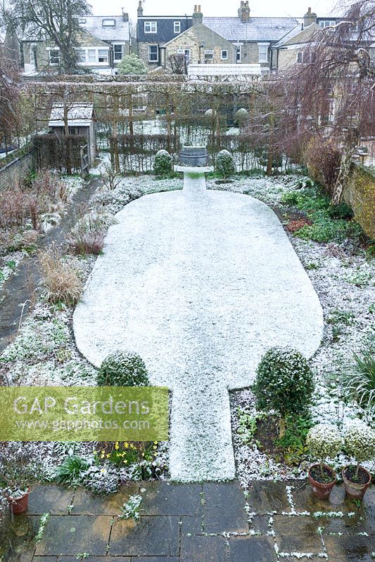 Walled town garden with snow