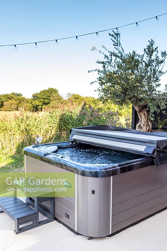 Jacuzzi on patio with view to countryside. 