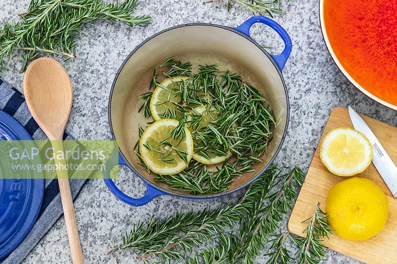 Saucepan with Salvia rosmarinus - Rosemary - foliage and slices of Lemon 