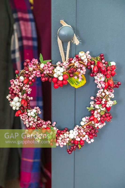 Autumnal berry wreath hanging on door knob