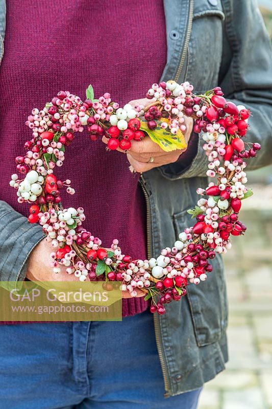 Woman holding berry wreath