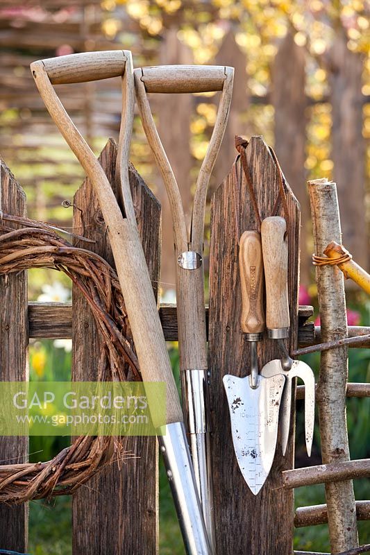 Garden tools showing wooden handles 