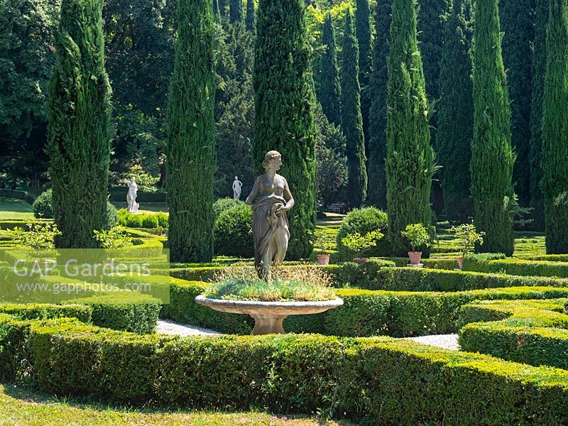 Parterre with statue, views of trees beyond