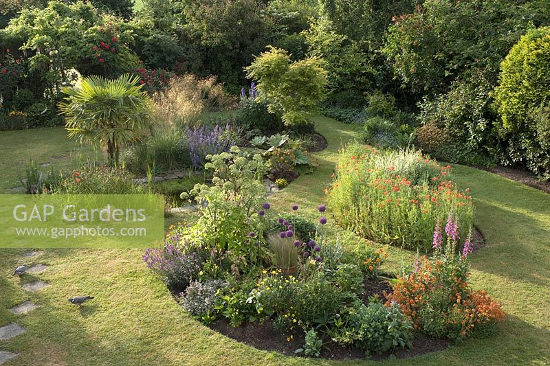 Colourful back garden with pond and island beds