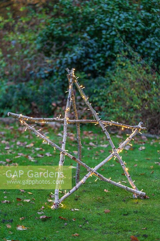 Illuminated natural star with fairylights made with lengths of Hazel sticks