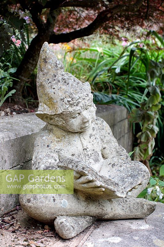 Vintage garden sculpture. A cast concrete garden gnome 