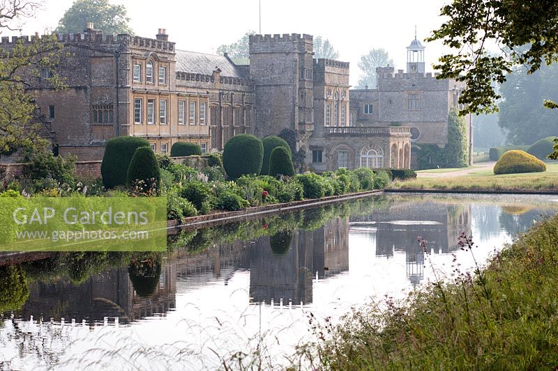 View of Forde Abbey from the Long Pond including borders and topiary