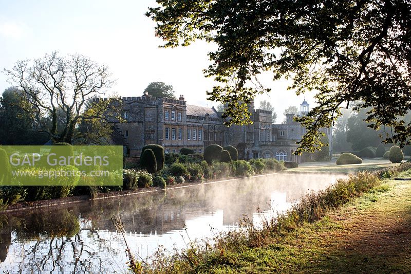 A misty early morning view of Forde Abbey seen from the Long Pond. 