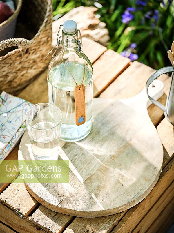 Wooden bottle tag  with painted bluebell, glass bottles and glasses