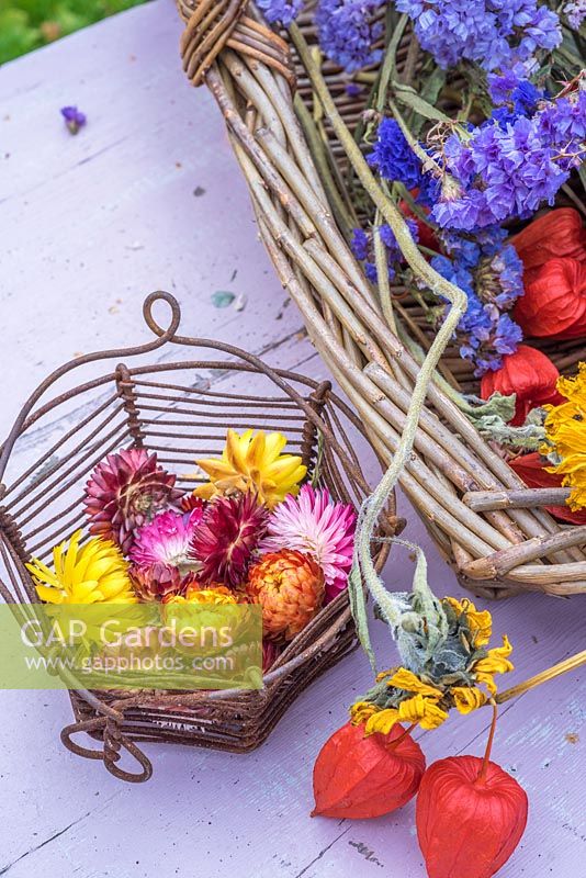 Everlasting flowers in tiny metal egg basket