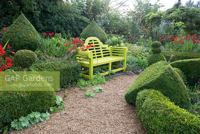 Lutyens style bench in Buxus parterre garden. 