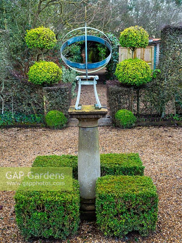 Armillary sun dial with clipped Buxus - Box - hedging and topiary 