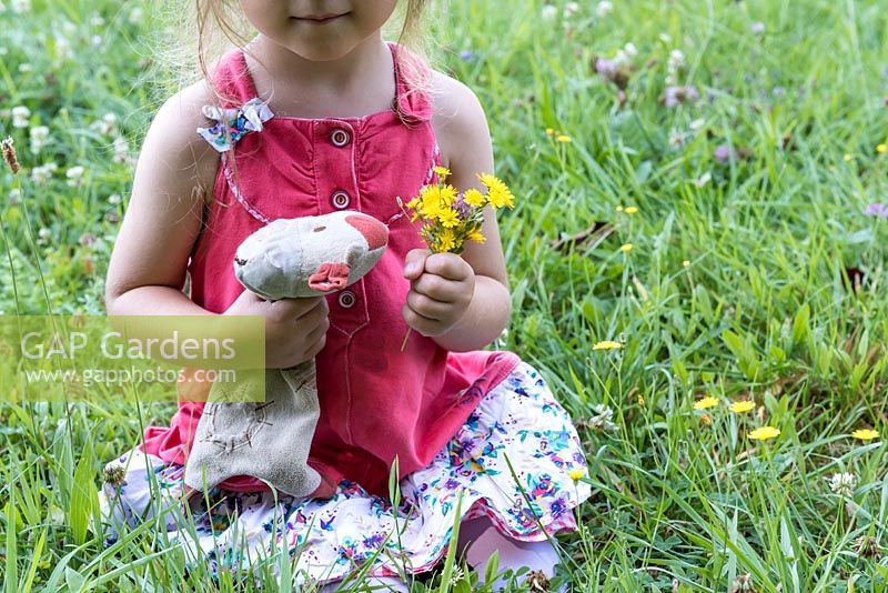 Girl picking wild flowers in a meadow