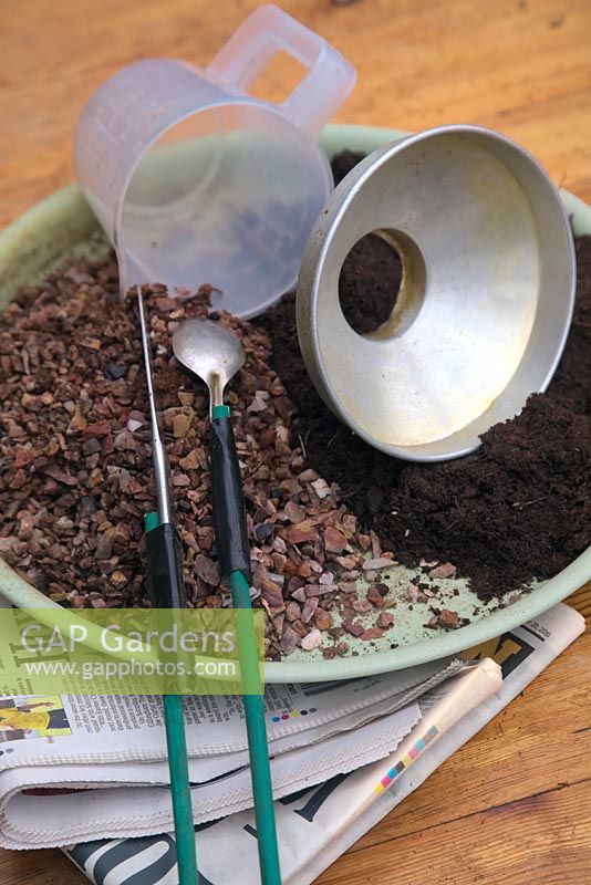 Equipment - compost, grit, pebbles, old newspaper, funnels, old cutlery suitably modified to use as tools. Step by step - How to plant a bottle garden with restricted neck. 