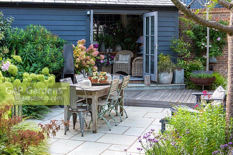 A contemporary courtyard garden with dining area and summerhouse 