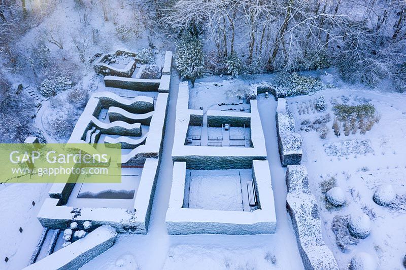 Drone overview of formal country garden covered in snow. Garden - Veddw 

