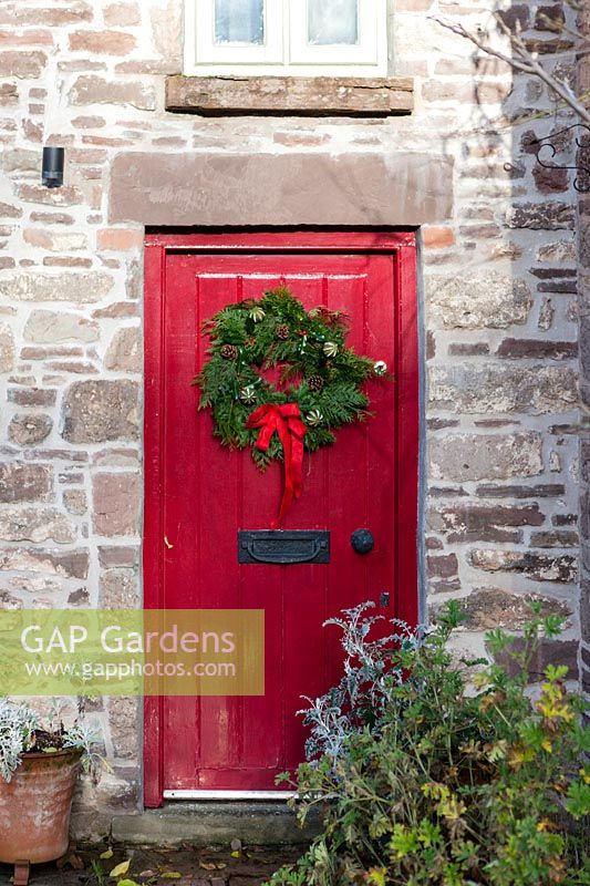 Christmas wreath on red door. 