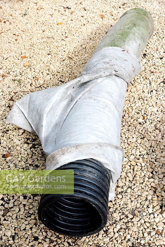 A length of 300mm Plain Ended Unperforated 'Solid' Twinwall Pipe wrapped twice with insulating thick pond liner underlay which provides winter protection for banana plants once lowered over the stem of the plant