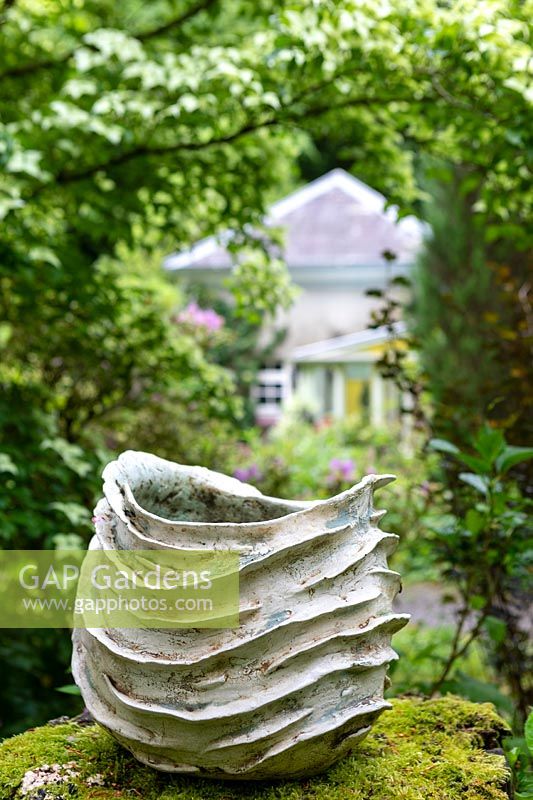 Ceramics on moss wall in a garden