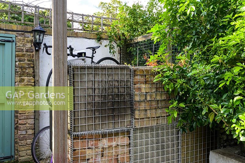 Gabion wall with bicycle storage by Earth Designs
