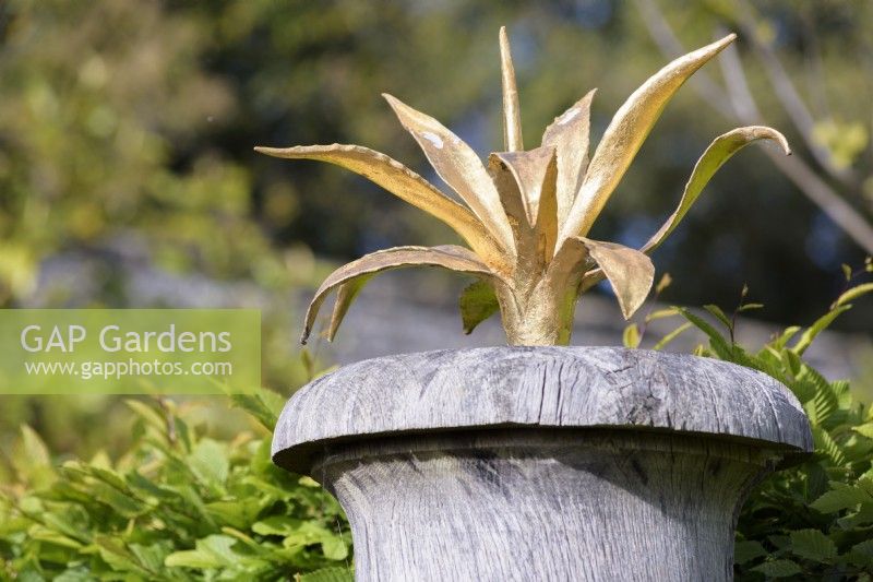 Gilded agaves atop green oak urns in the Collector Earl's Garden at Arundel Castle, West Sussex