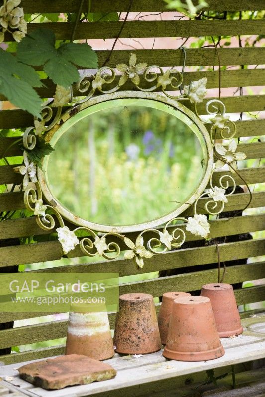 Decorative mirror used in a cottage garden in June