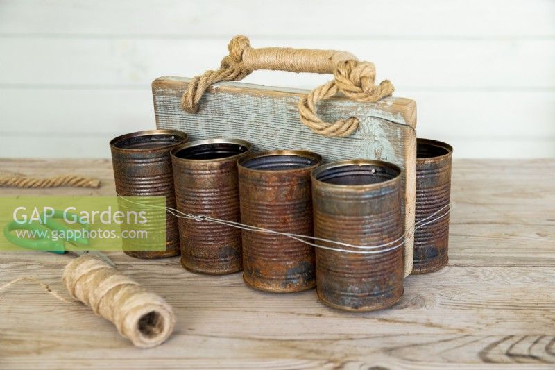Finished shot of tin can caddy on wooden surface