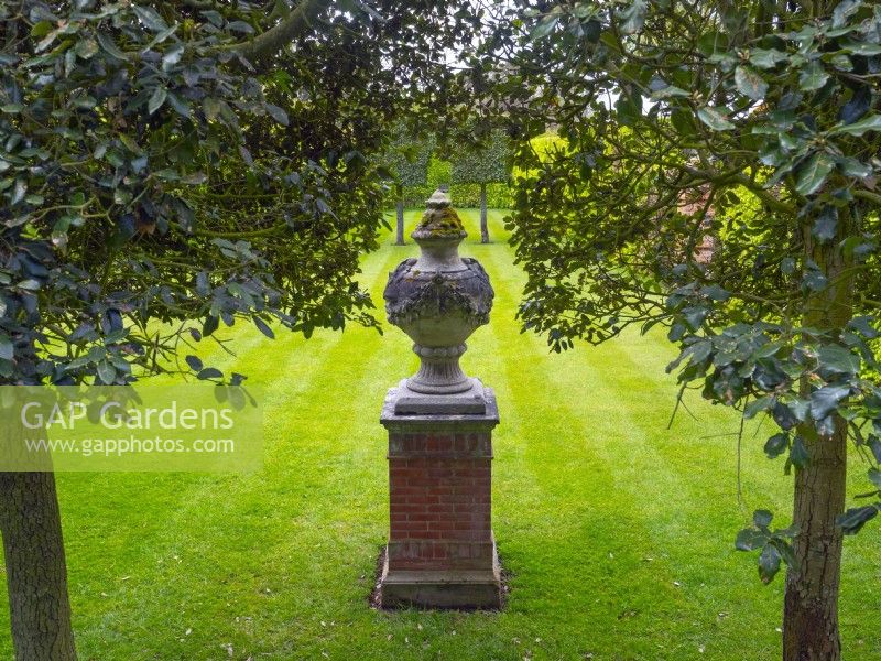 Urn on plinth Green Court garden at East Ruston Old Vicarage, Norfolk April