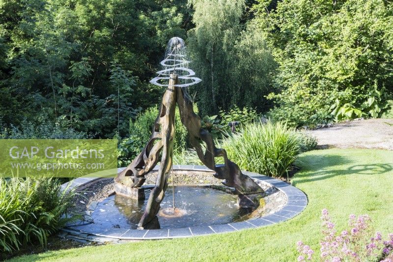Fountain on wooden structure above pool made by Jane Hazelwood. July