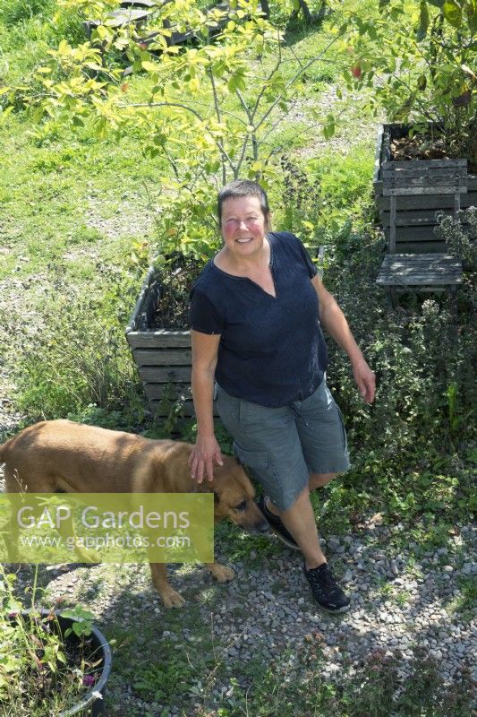 Anita van Zantvoort owner tea garden: 'Under the green heaven' and her dog.