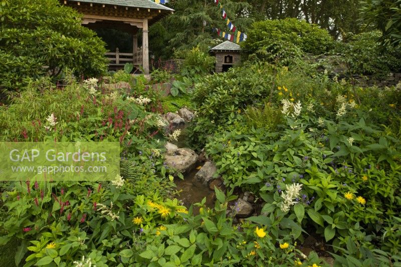 The Trailfinders 50th Anniversary Garden containing traditional Nepalese wooden architecture surrounded by plants from the Himmalayan foothills.