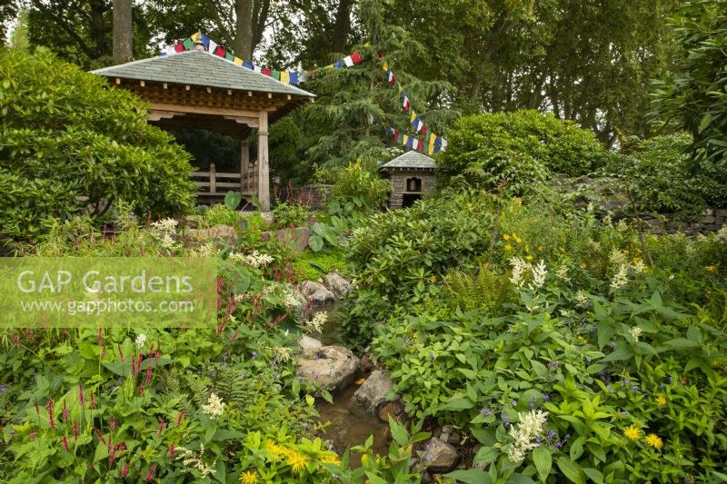 The Trailfinders 50th Anniversary Garden containing traditional Nepalese wooden architecture surrounded by plants from the Himalayan foothills. 