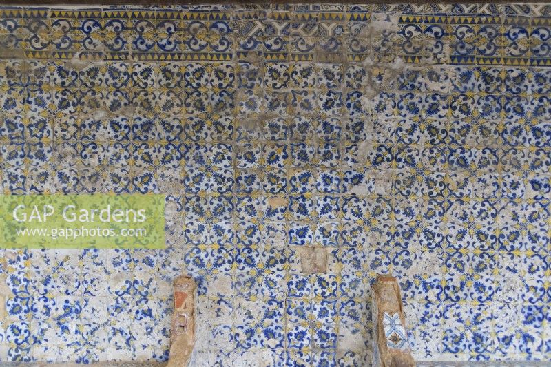 Wall of glazed blue tiles known as Azulejos in poor condition. Seixal, near Setubal, Portugal. September