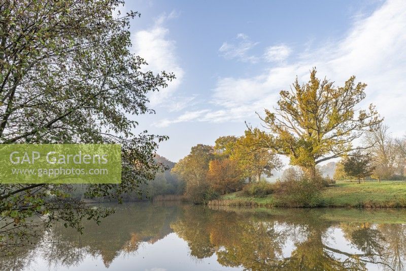 View of a lake in a country garden in autumn - November