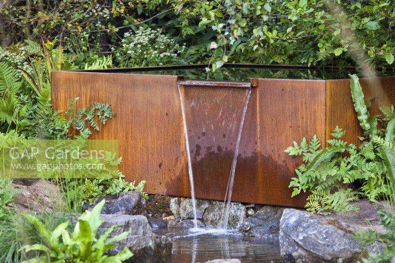 Rusty waterfall feature. The Yeo Valley Organic Garden, RHS Chelsea Flower Show 2021 Design: Tom Massey