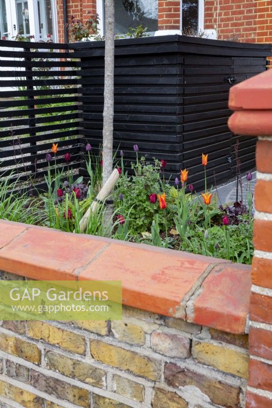 Front garden with low brick wall and sloping coping