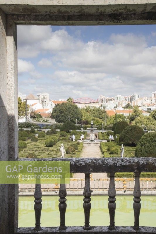 View over balustrade of the Kings Gallery to the Formal Garden parterre of box hedges and yew mounds. View to city beyond the garden. Lisbon, Portugal, September.