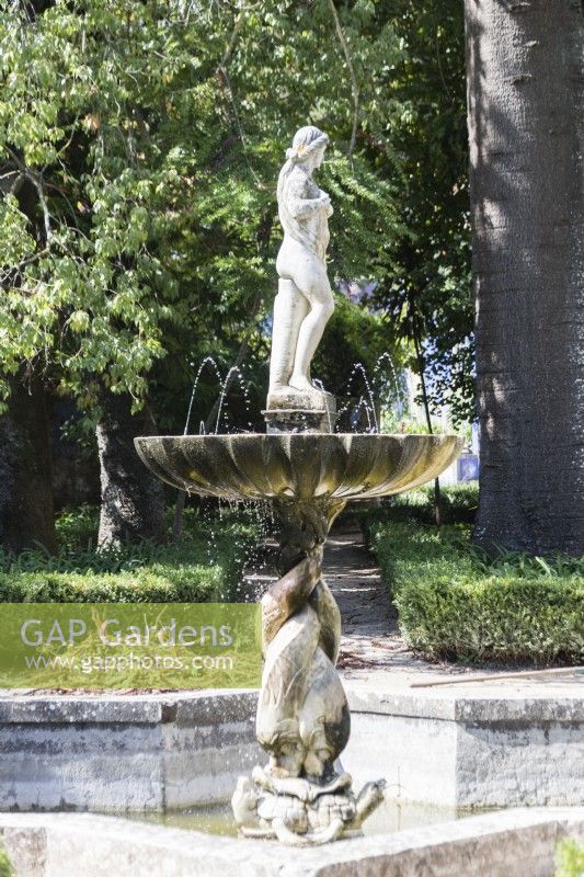 Fountain in the Garden of Venus. Raised pool with fountain and sculpture figure. Lisbon, Portugal, September.