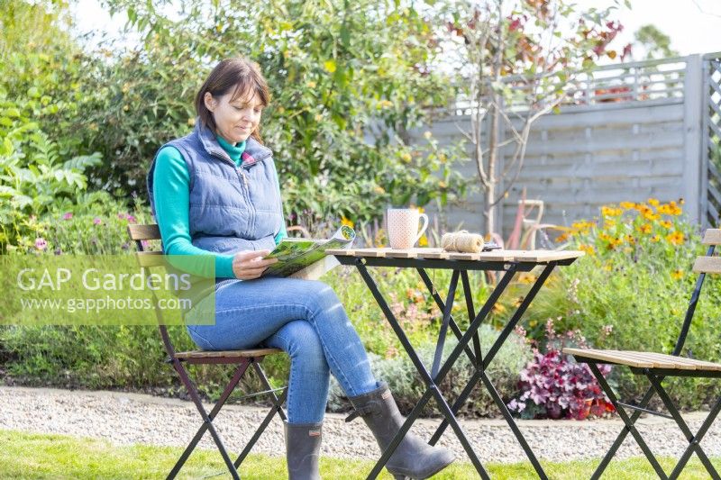 Woman reading magazine in the garden