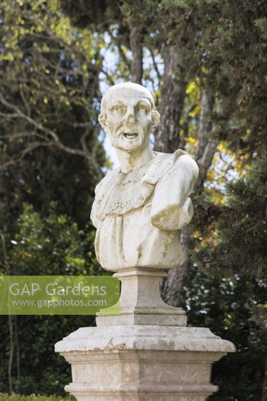 Bust on plinth in the Pensile Garden. Queluz, Lisbon, Portugal, September. 