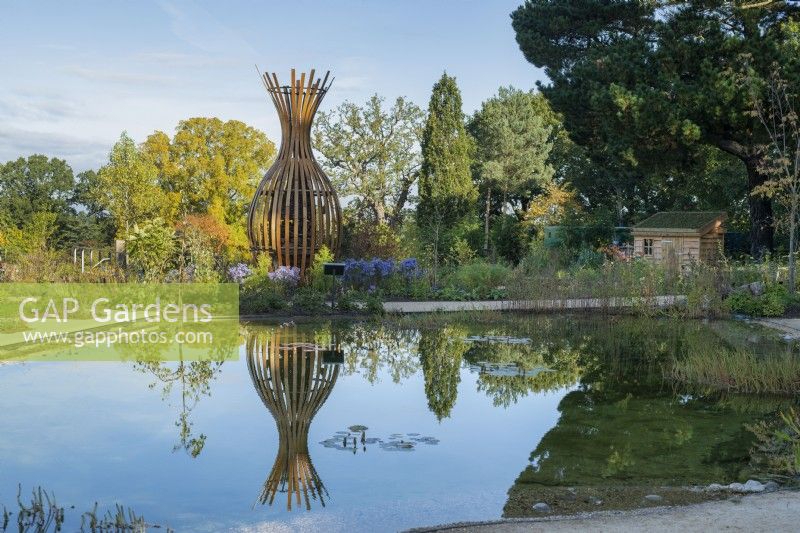 Tom Hare Sculpture at RHS Wisley in the wildlife garden in autumn