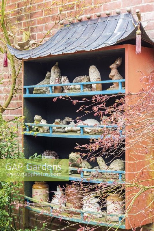 Collection of stone garden animals and birds in oriental wall display
