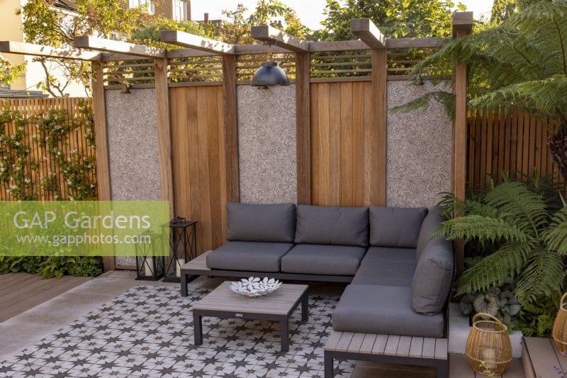 Pergola and patio with seating in contemporary garden 
