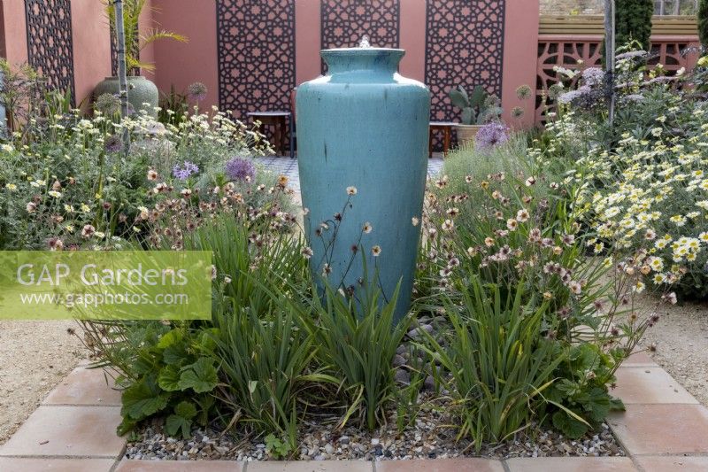 Mediterranean style garden with tall ceramic container water feature